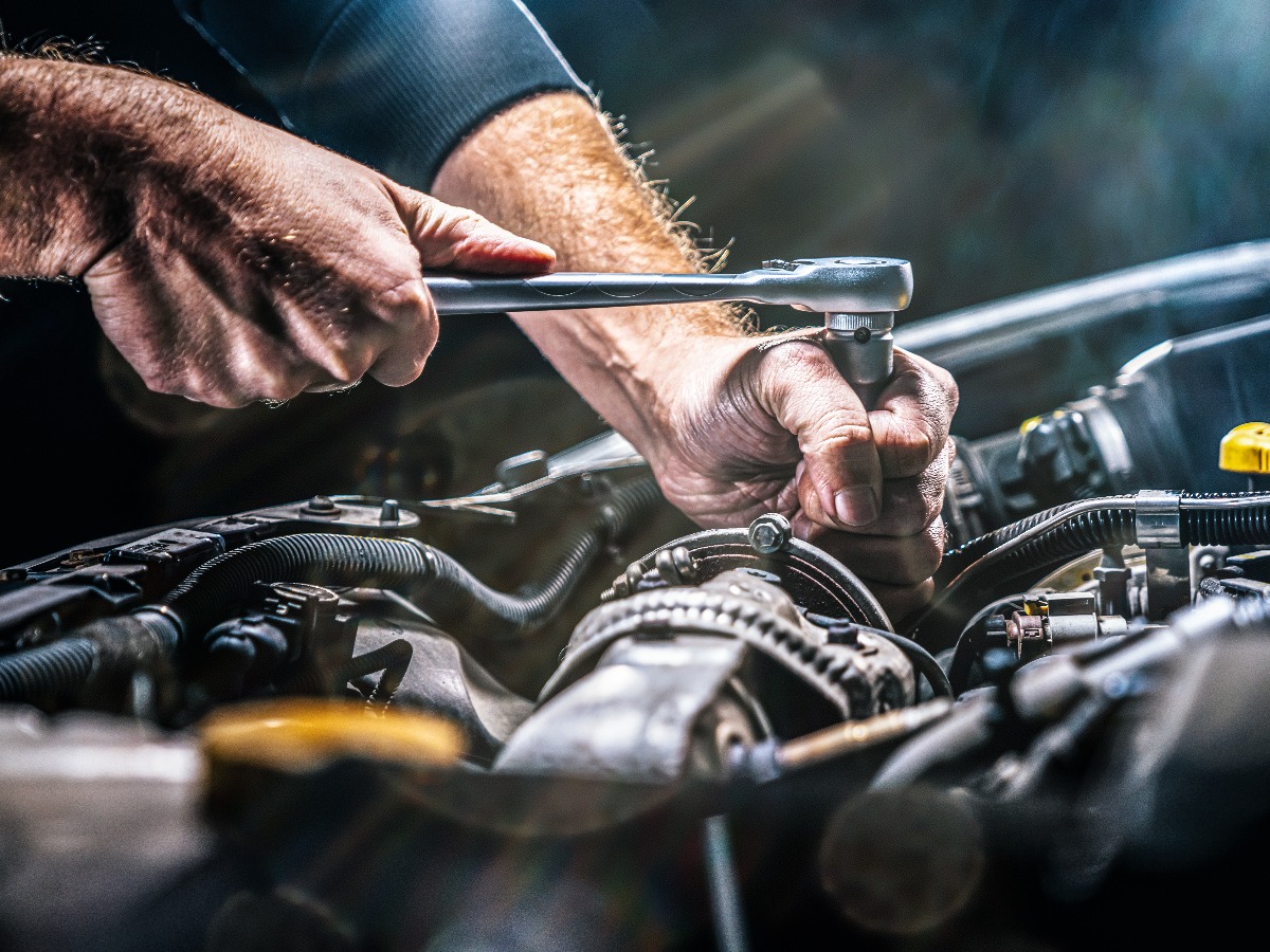 Auto mechanic working in garage repair service jpg